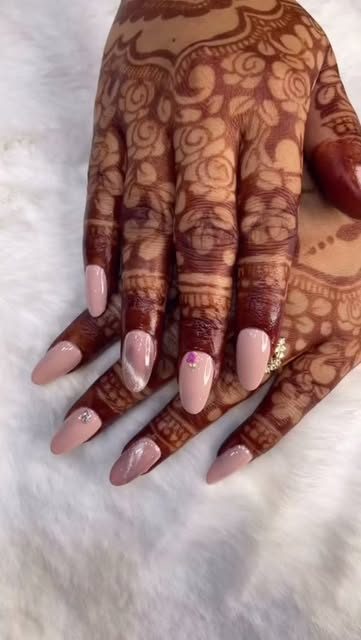 Soft pink almond nails with bridal mehendi